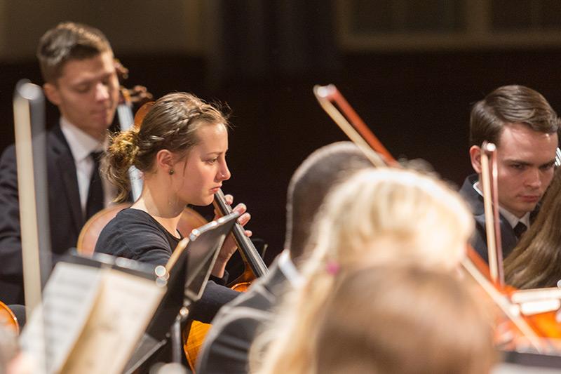 Orchestra students playing string instruments