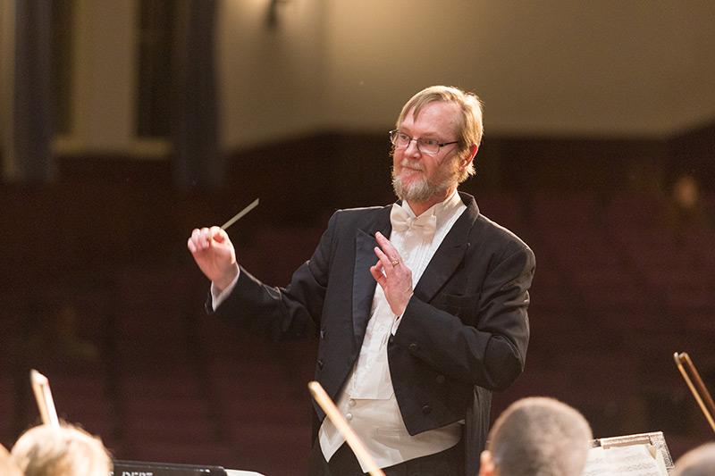 Orchestra conductor leading an group