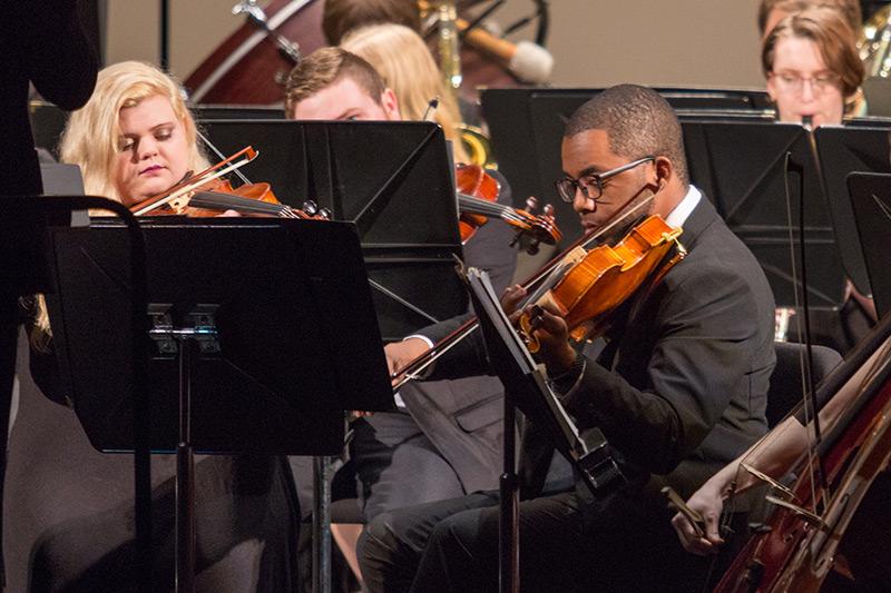 Orchestra students playing string instruments