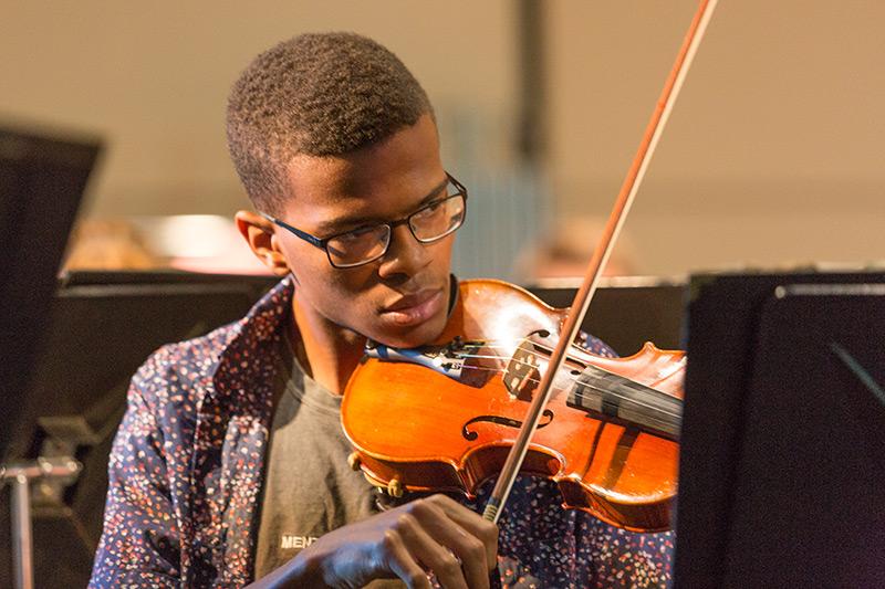 Orchestra student playing a violin