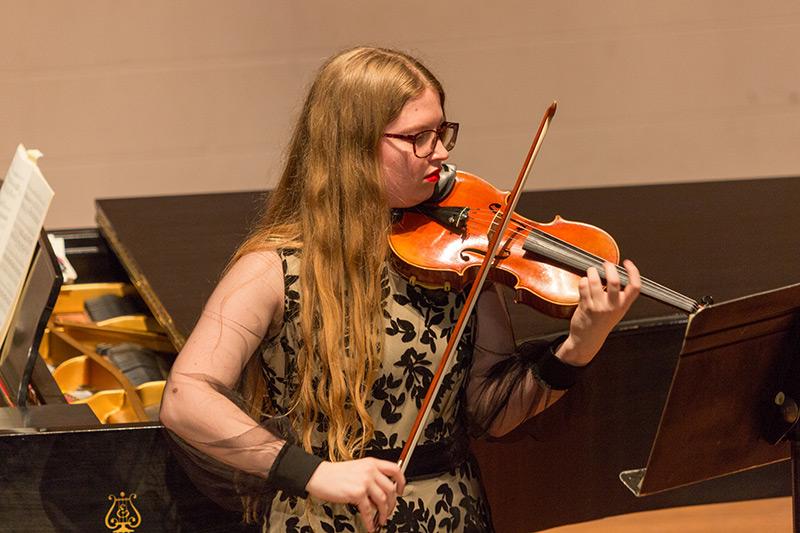 Orchestra student playing a violin