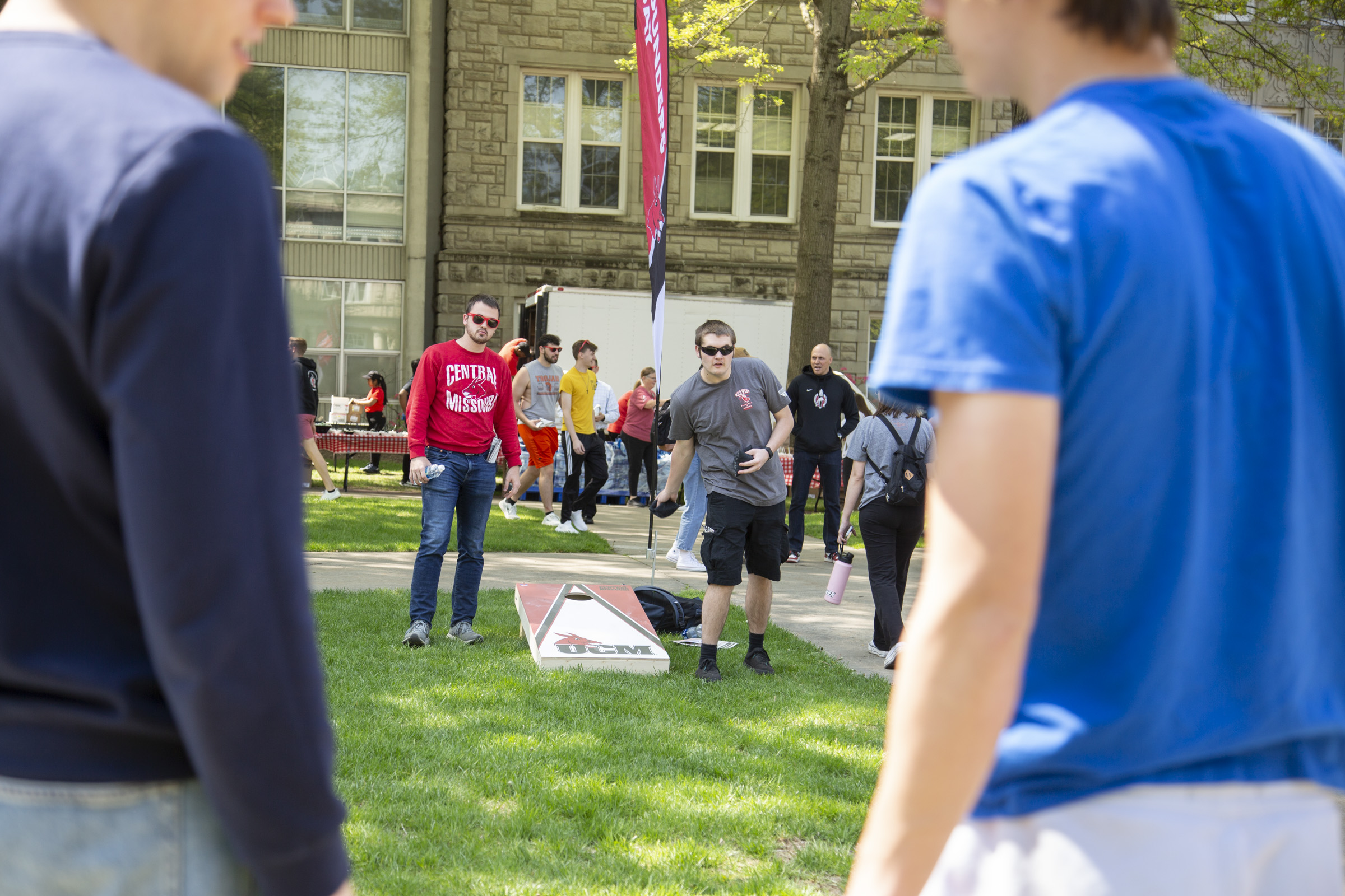 Students play a game of cornhole.