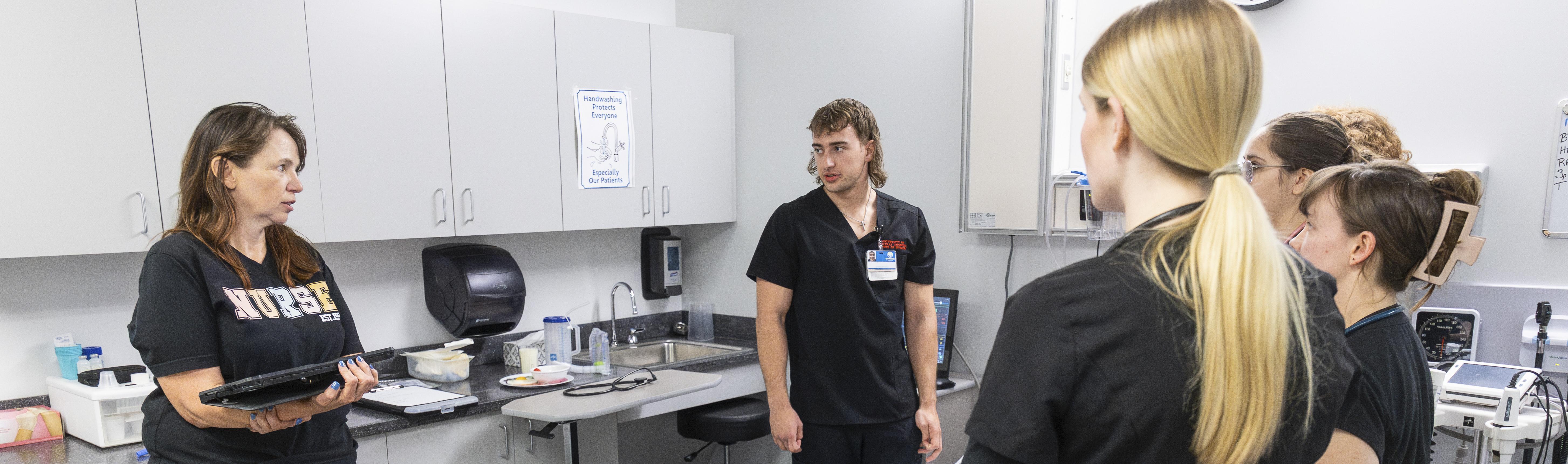 UCM nursing professor and students in a simulation lab