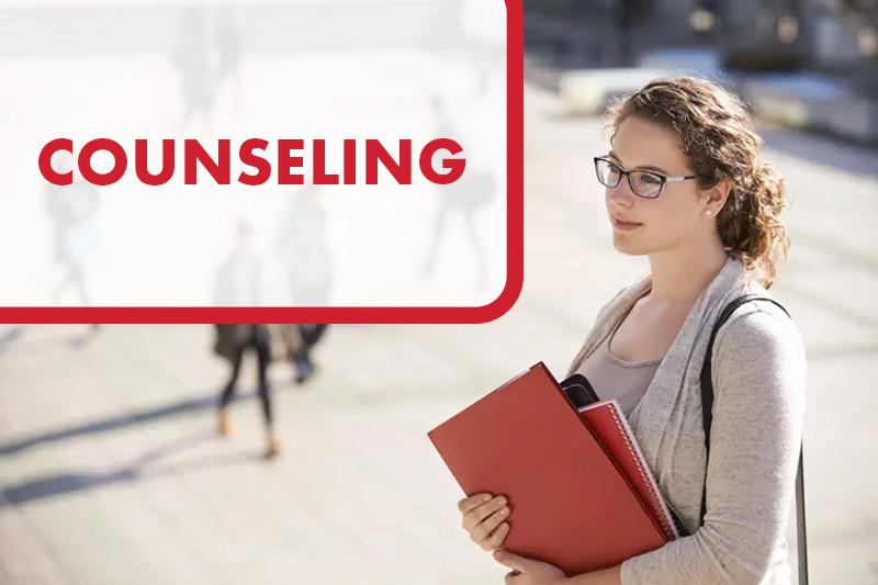 A counselor standing outdoors