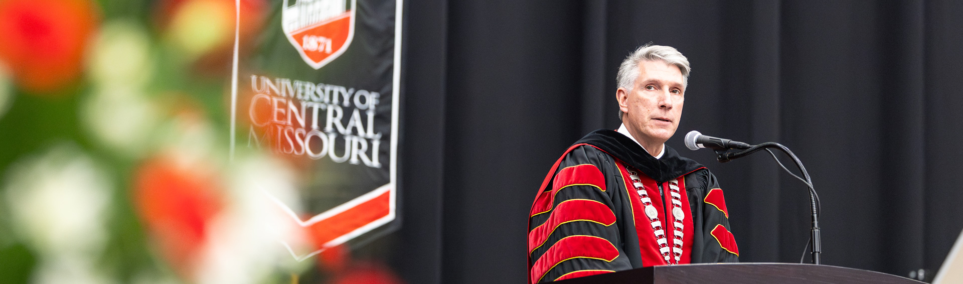 Dr. Best speaking at a commencement ceremony