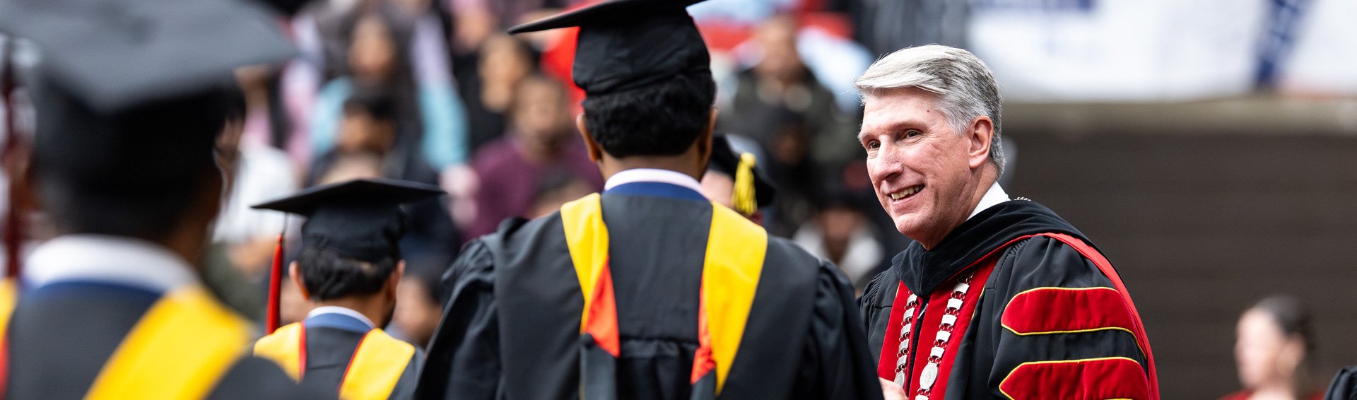 Dr. Best with graduates at a commencement ceremony