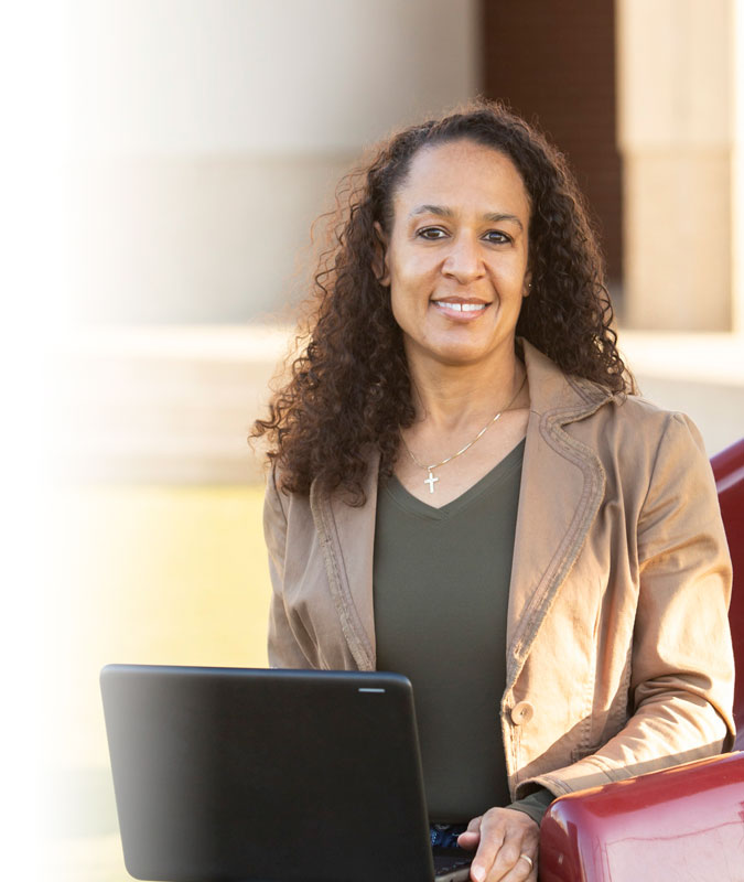 A teacher holding a laptop