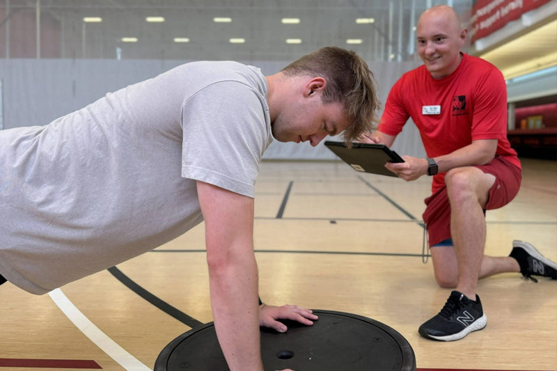 A UCM student working with a personal trainer at the Rec