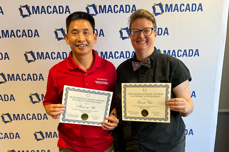 Brenda Fuhr and Miaozong Wu posing with certificates