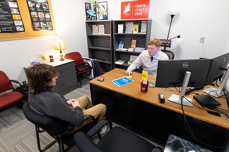 A student and coach in a Financial Literacy Center session