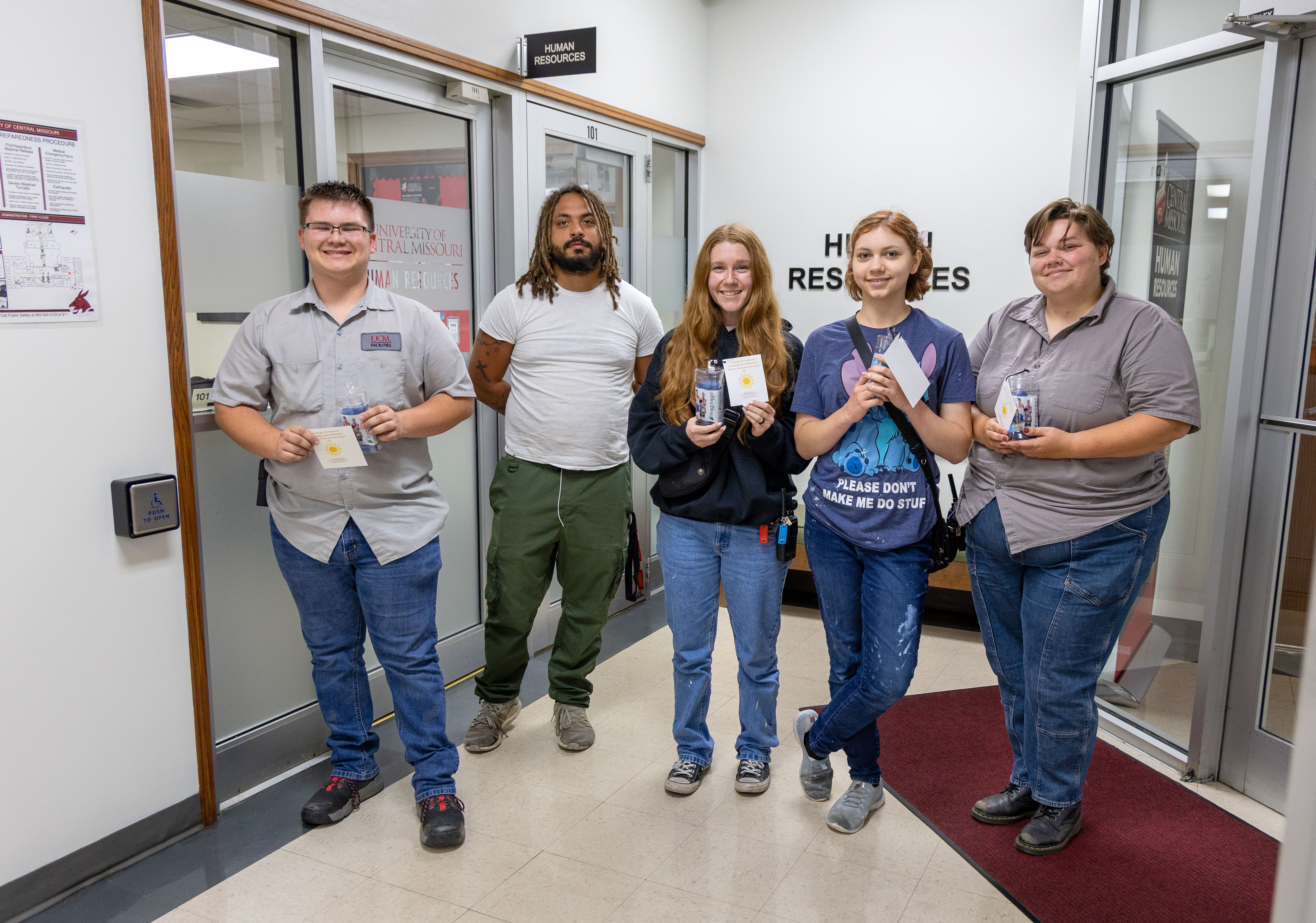 FPO employees pose for a photo outside the HR office