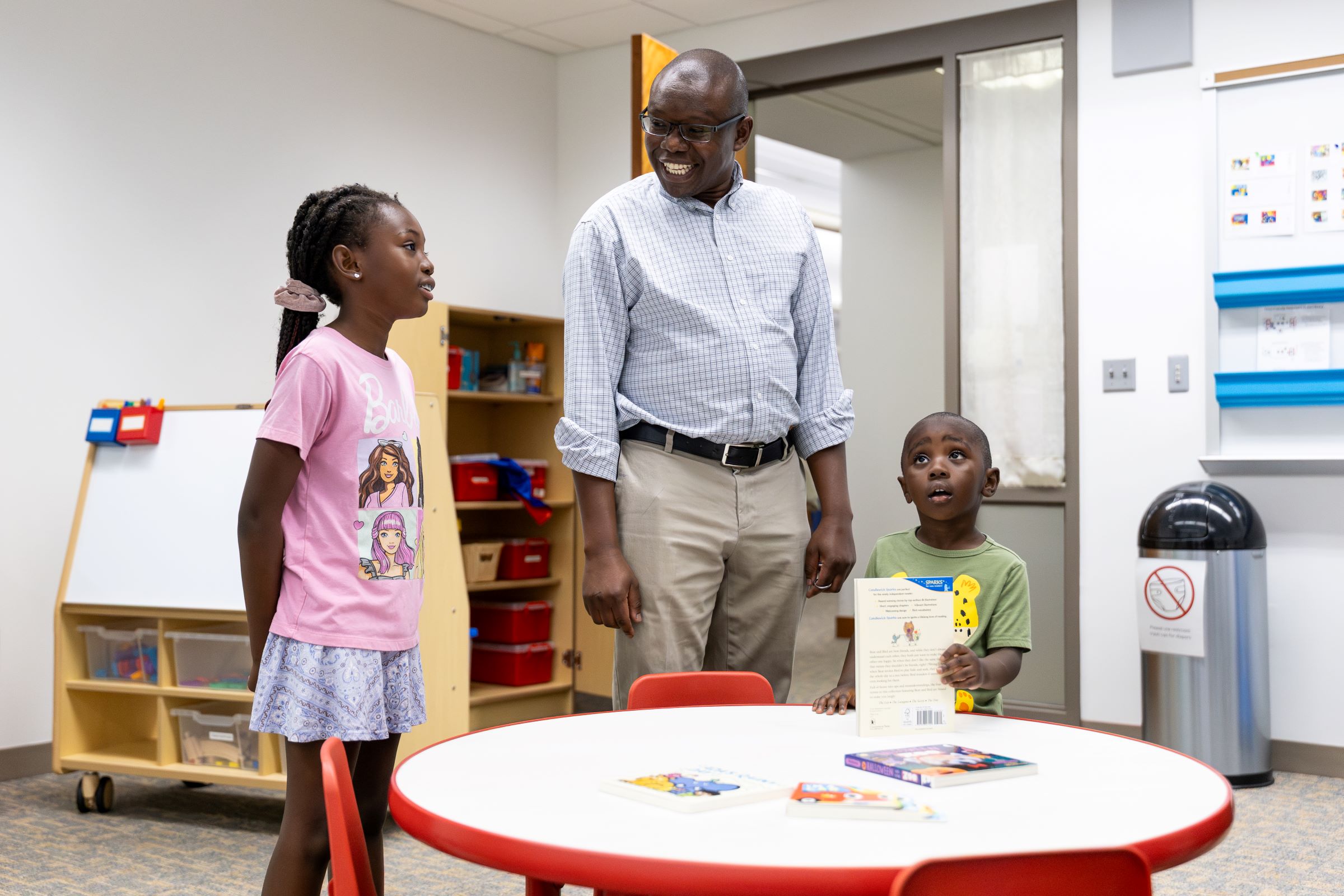 Josiah Nyangau, assistant vice provost of Assessment and Planning, and his children visit the family study room