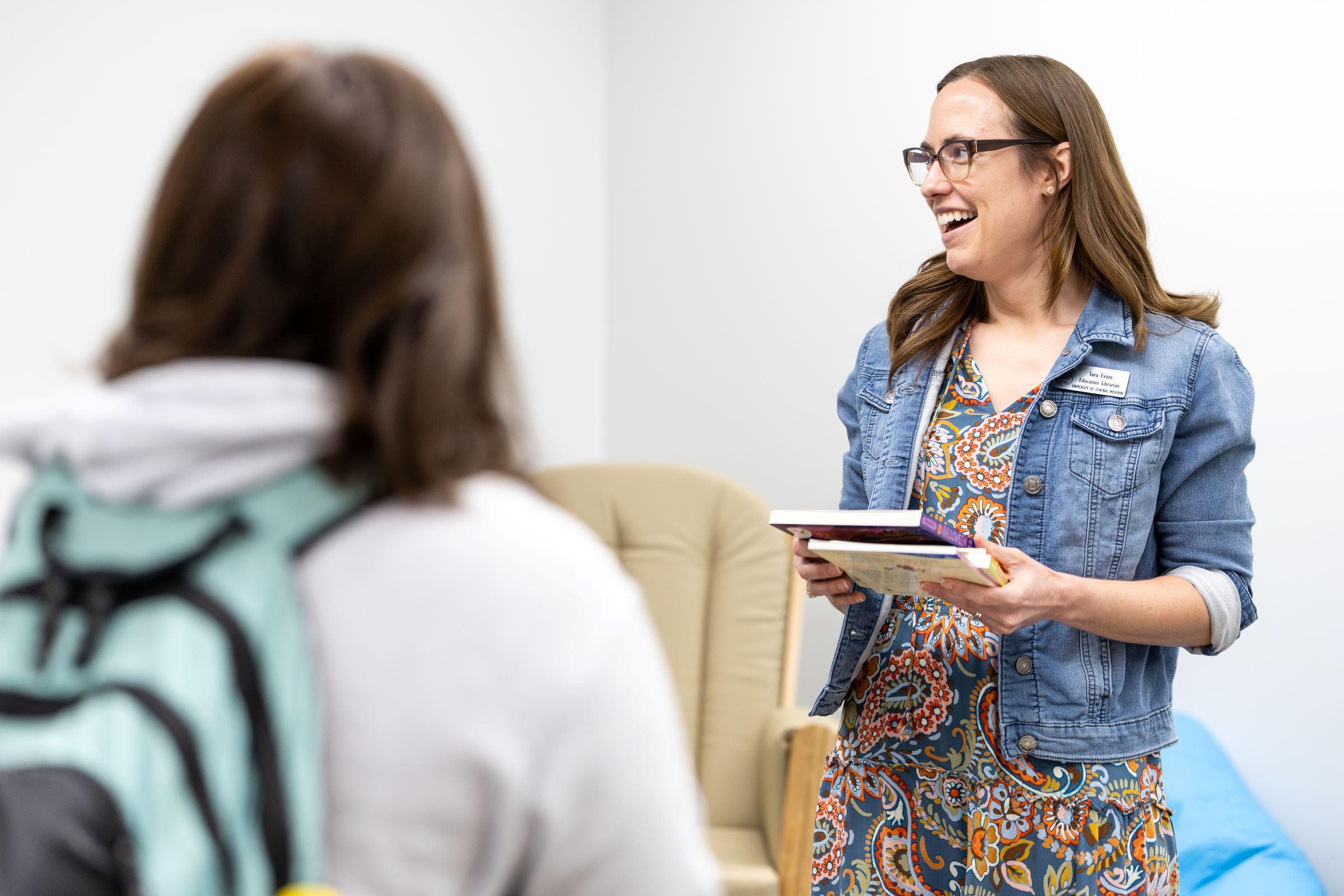 College of Education Subject Librarian Sara Evans greets reception guests