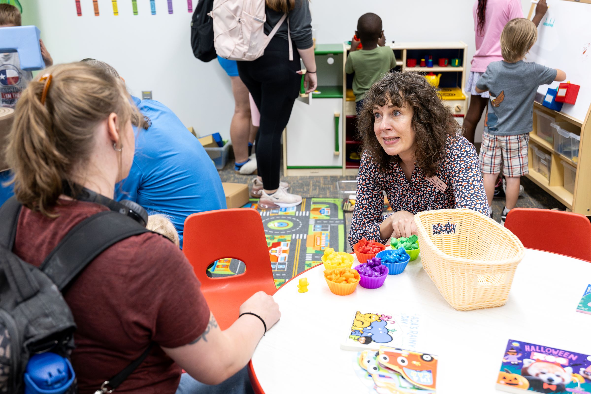 Assistant Dean of Library Services Maya Kucij talks with a student parent in the family study room