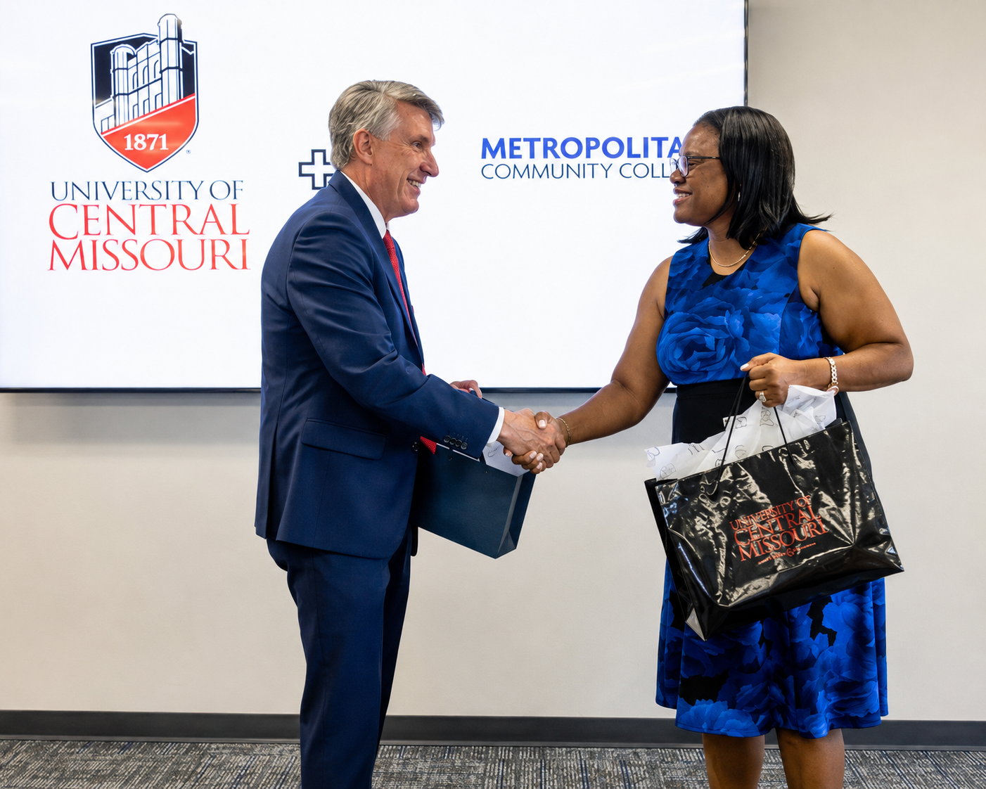 MCC UCM MOU University of Central Missouri President Roger Best and Dr. Kimberly Beatty, Chancellor and CEO of Metropolitan Community College, shake hands after signing a new memorandum of agreement designed to create a more direct, affordable, and supportive pathway for MCC students who plan to complete an associate degree and continue toward a bachelor’s degree at UCM.