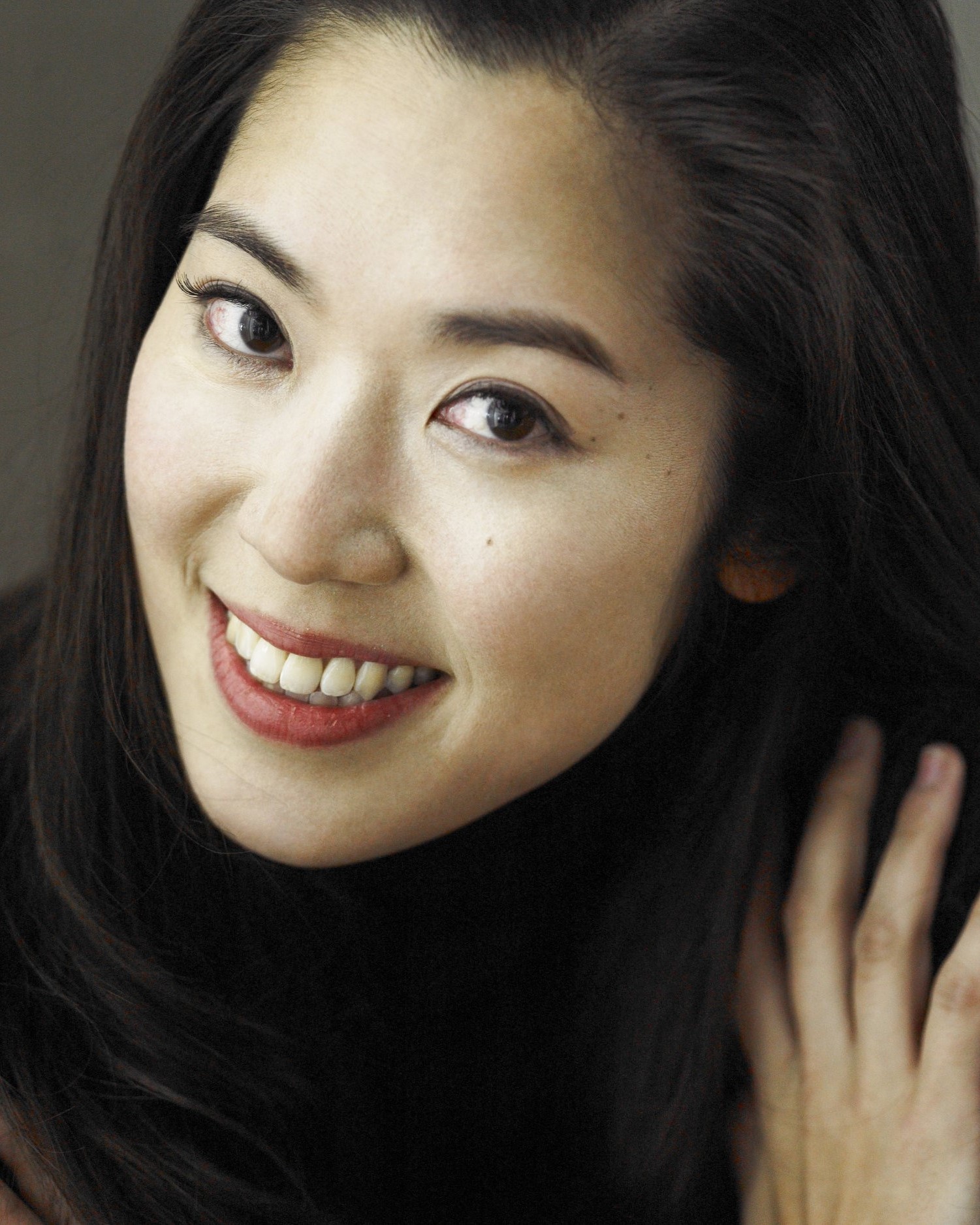 A woman poses for a portrait and is seen from the shoulders up