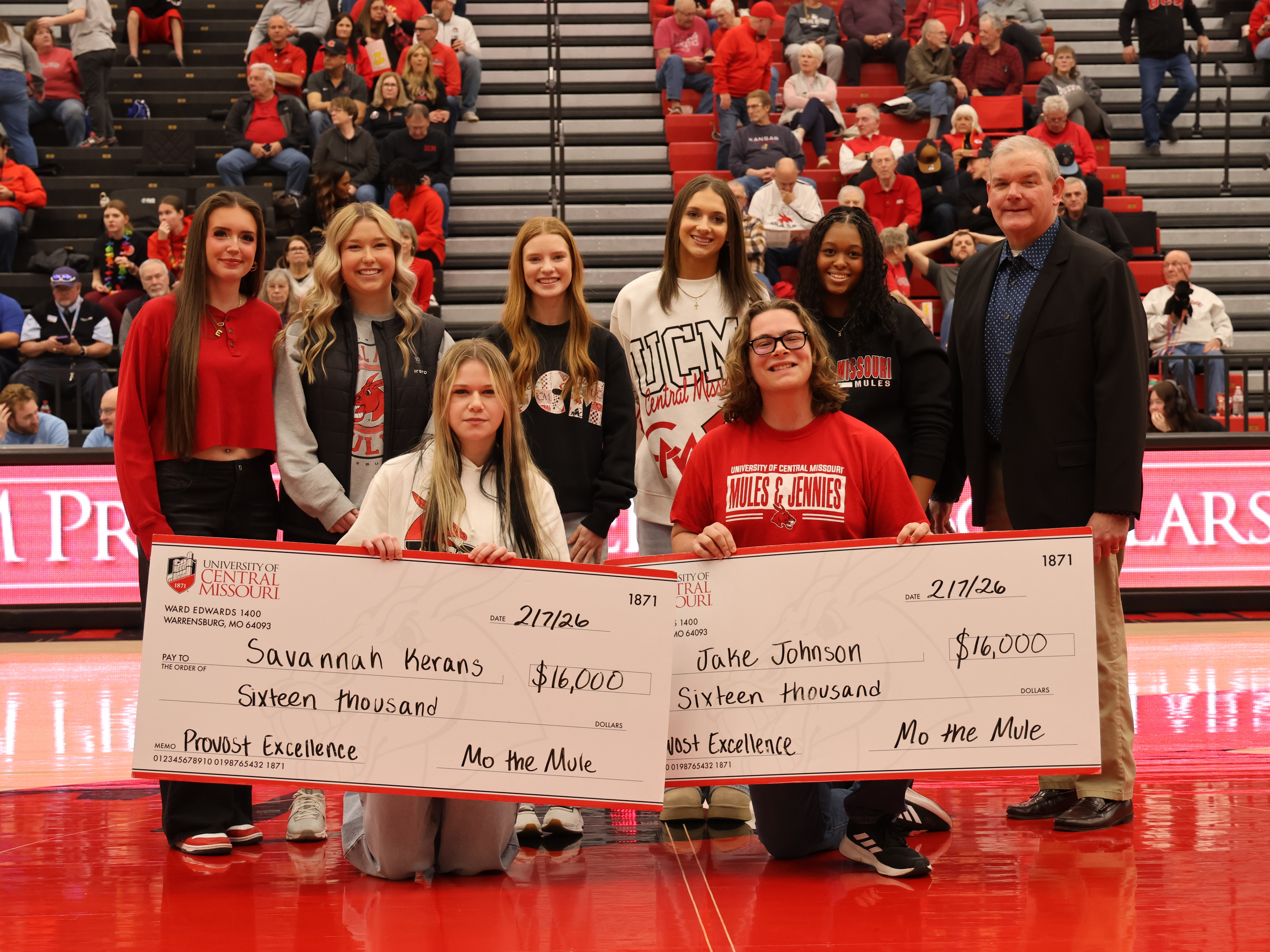 A group of students and the provost at the Hughes Athletics Center