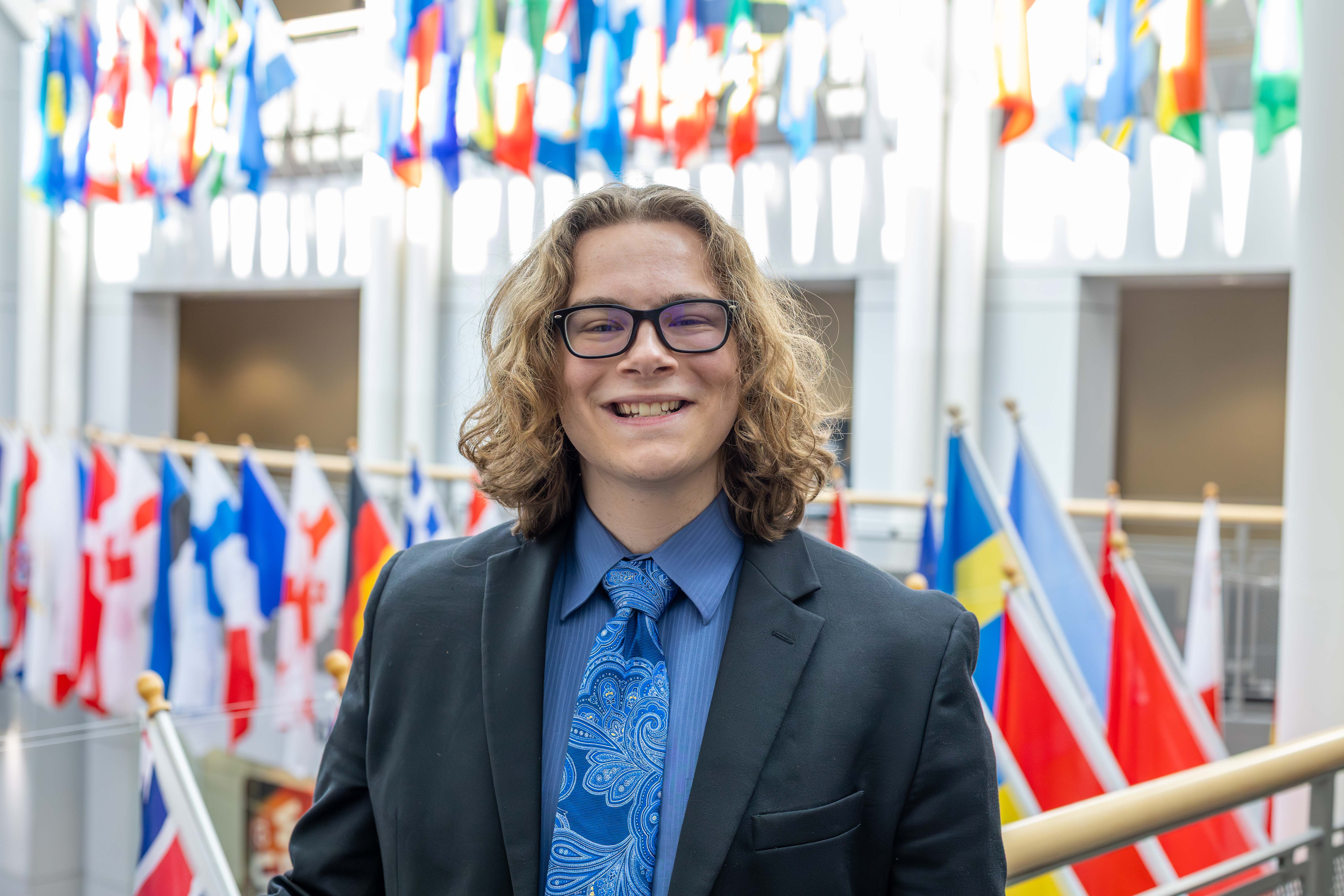 Jake Johnson stands in the Ward Edwards Building