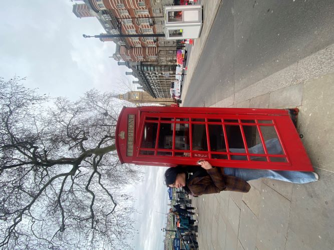 Student in London phone booth.