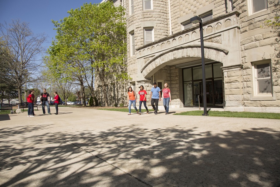 Students walking outside on a spring day