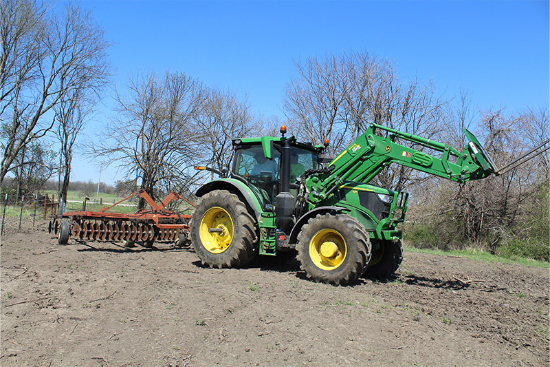 A tractor pulling a discing tool