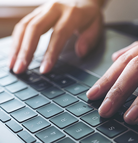hands typing on a keyboard