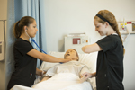 Nursing students taking vital signs in nursing lab