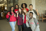 group of students showing "snouts out" hand symbol