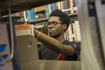 student selecting book in the libary