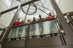 students looking down from stairwell in library