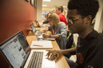 students sitting at laptop bar in Elliott Student Union