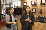 student trying on graduation gown