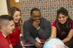 students looking at globe