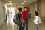 three students in the hallway of Student Recreation and Wellness Center