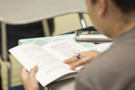 over the shoulder view of student looking at text book