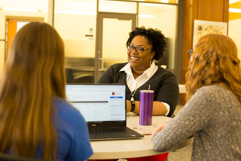 Two students meeting with a tutor