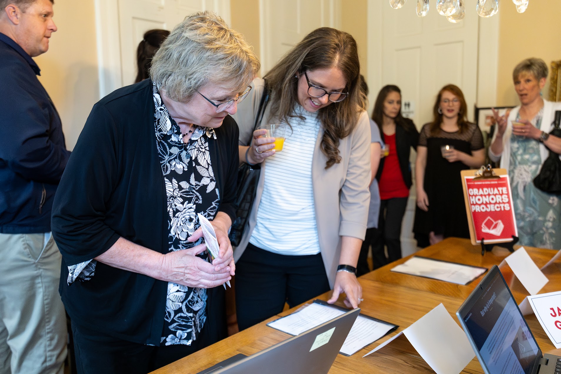 Dr. Ann McCoy viewing Honors Projects.