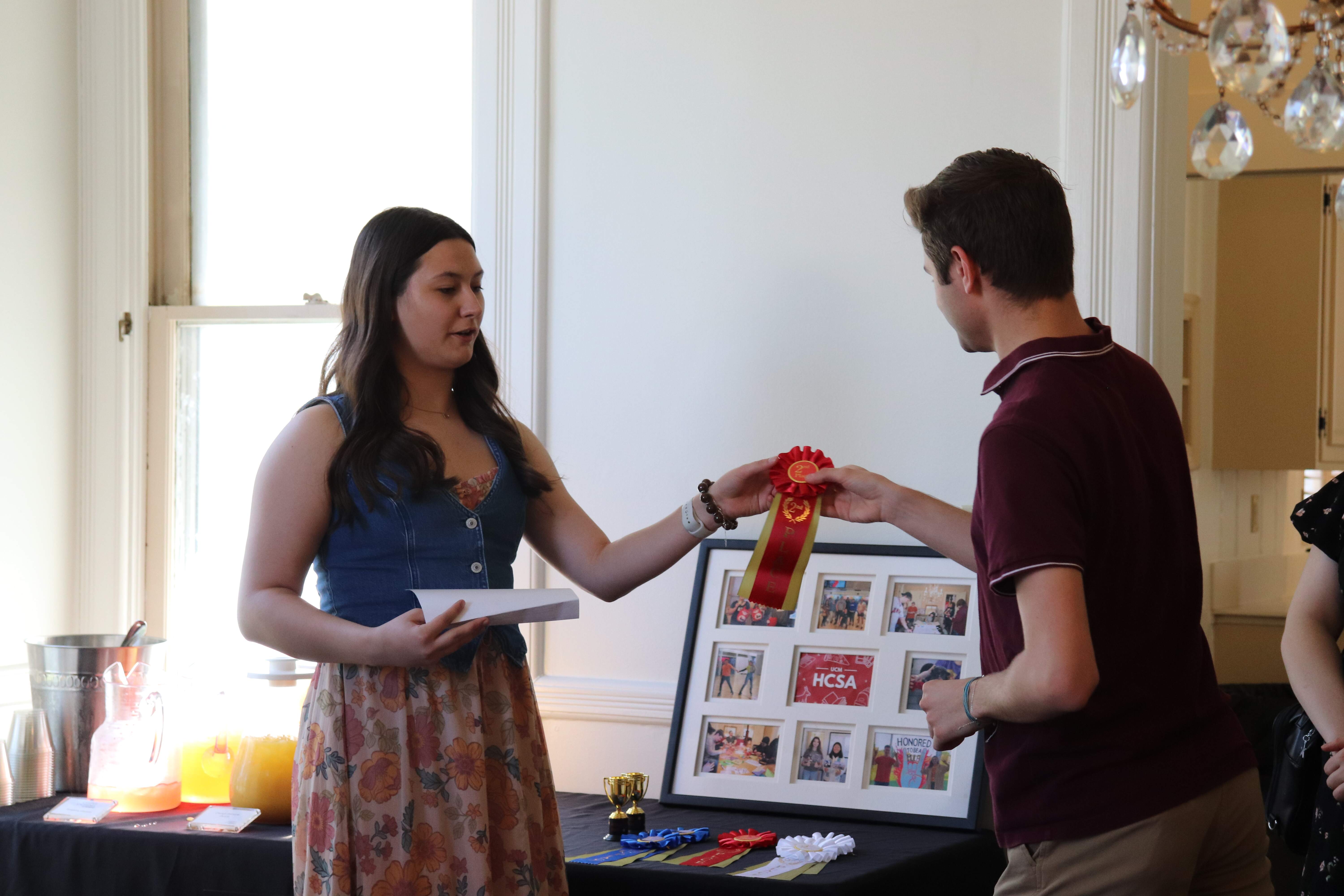 An honors student receiving an award in an Honors College photo competition.